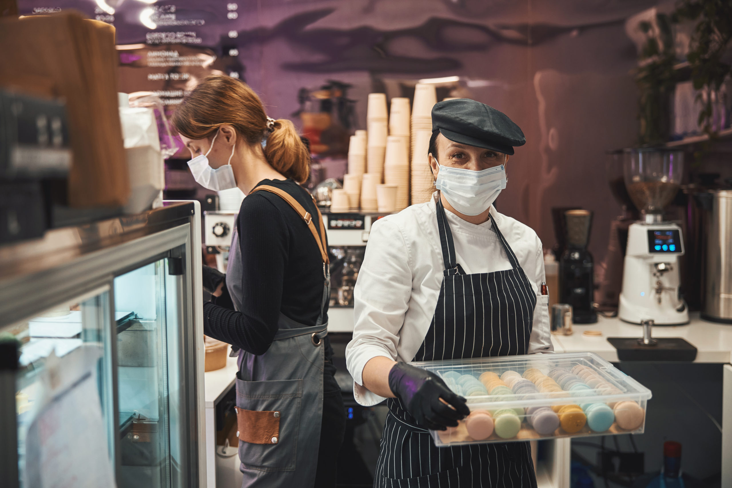 Busy cafe workers running errands at a nice espresso bar